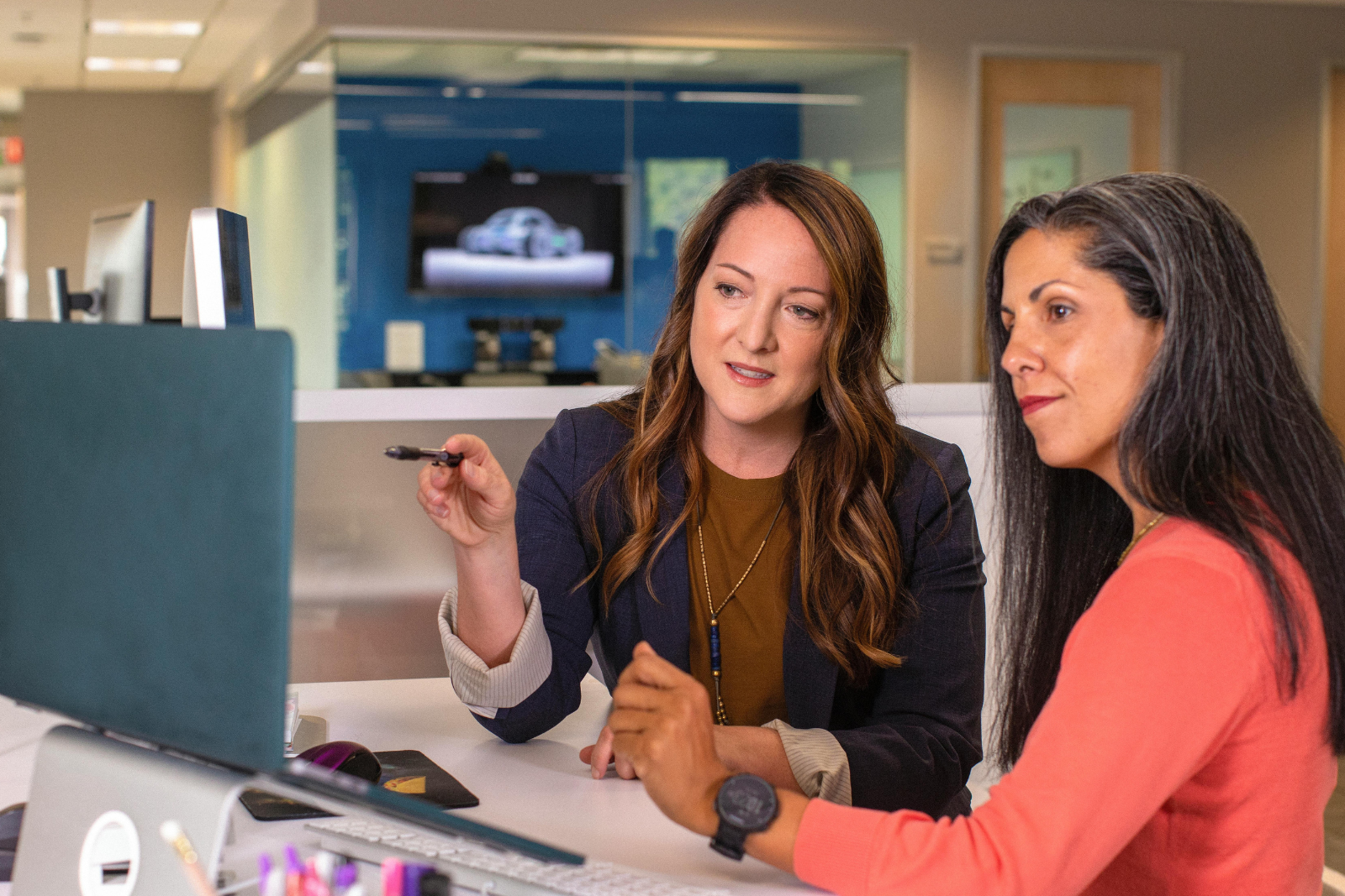 Marketers analyzing the customer journey on a laptop